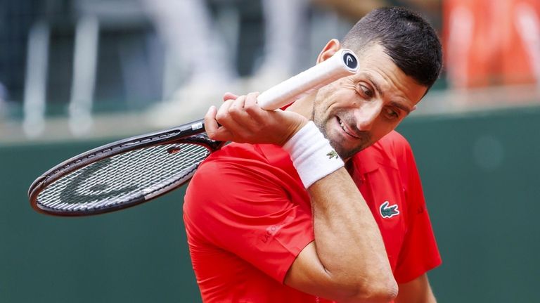 Serbia's Novak Djokovic reacts after losing a point against Germany's...