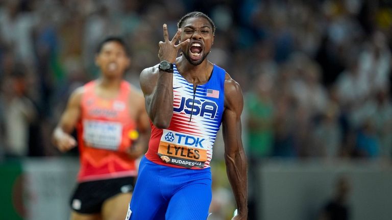 Noah Lyles, of the United States celebrates anchoring his team...