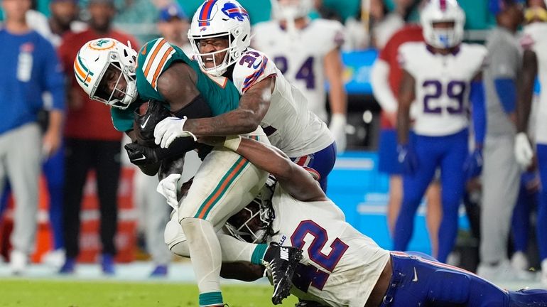 Miami Dolphins running back De'Von Achane is tackled by Buffalo...