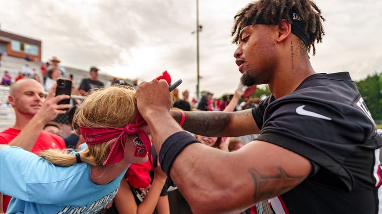 Atlanta Falcons cornerback A.J. Terrell (24) signs autographs during an...