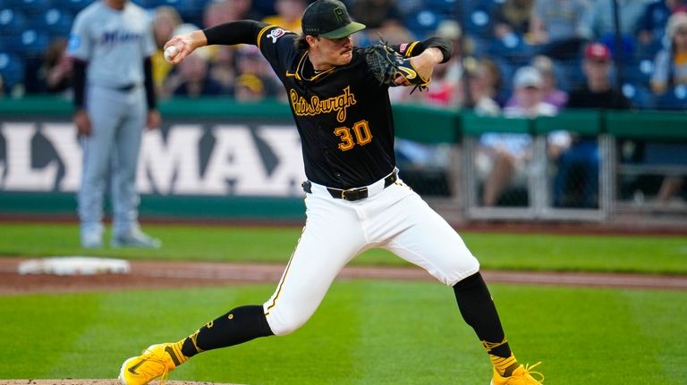 Pittsburgh Pirates starting pitcher Paul Skenes delivers during the first...