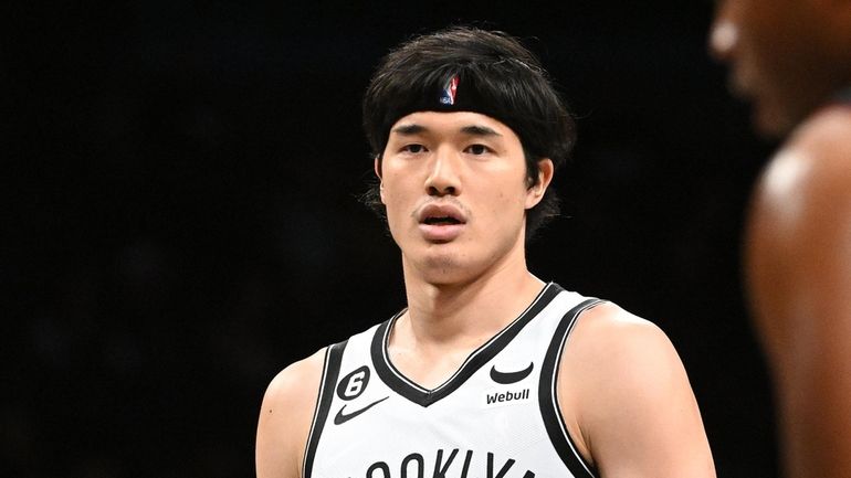 Nets forward Yuta Watanabe looks on before shooting a free...