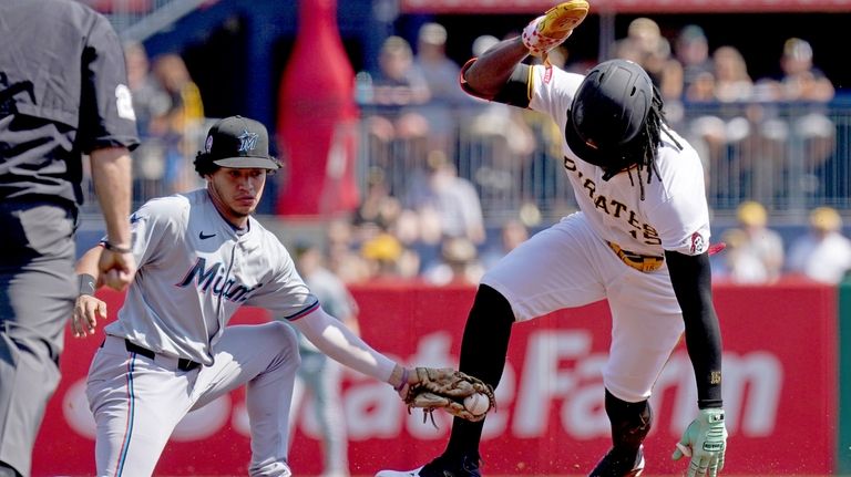 Pittsburgh Pirates' Oneil Cruz, right, steals second base ahead of...