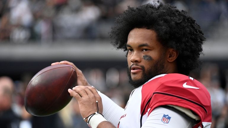 FILE - Arizona Cardinals quarterback Kyler Murray warms up on...