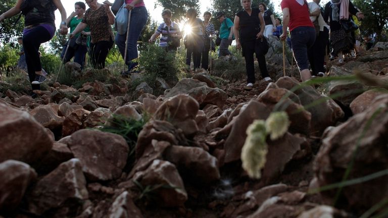 Pilgrims walk on a rocky terrain to say their prayers...