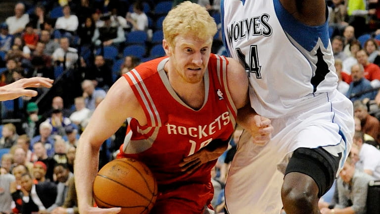 Former Houston Rockets' Chase Budinger, left, drives around Minnesota Timberwolves'...