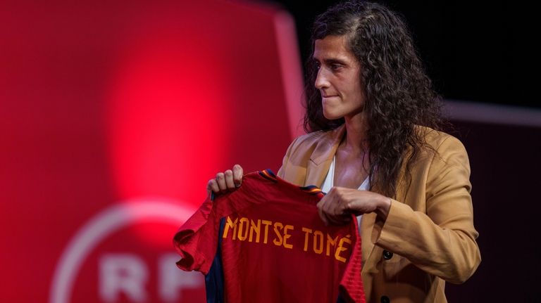 Spain's new women's national team coach Montse Tome, holds a...