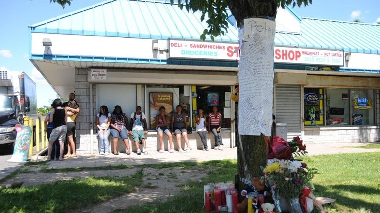 Friends at a makeshift memorial on Crooked Hill Road in...