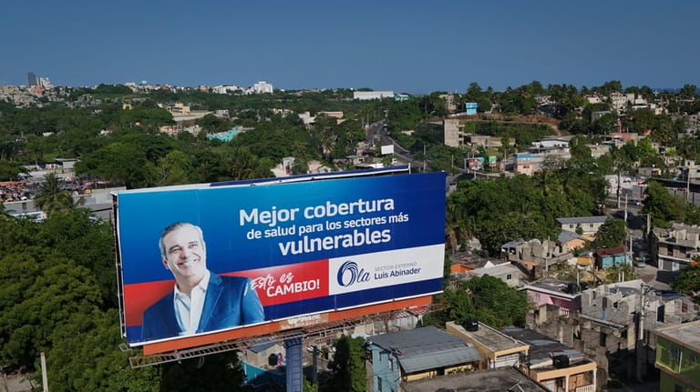 A billboard of presidential incumbent candidate Luis Abinader in Santo...