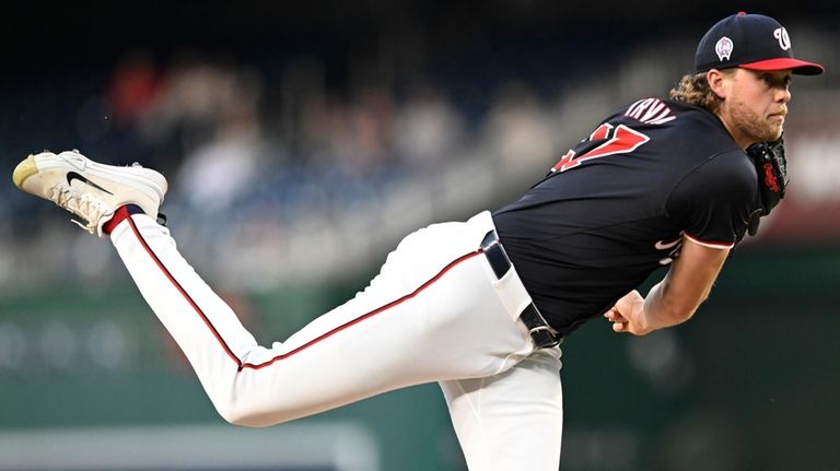 Washington Nationals starting pitcher Jake Irvin follows through during the...