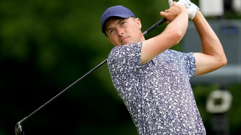 Jordan Spieth watches his tee shot on the sixth hole...