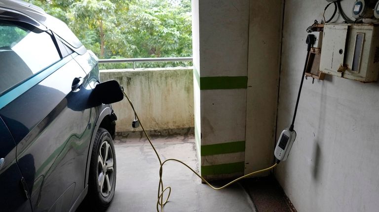 A car gets charged at the Electric Vehicle charging station...