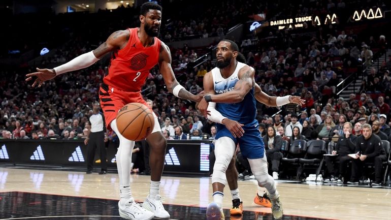 Minnesota Timberwolves guard Mike Conley, right, passes the ball as...