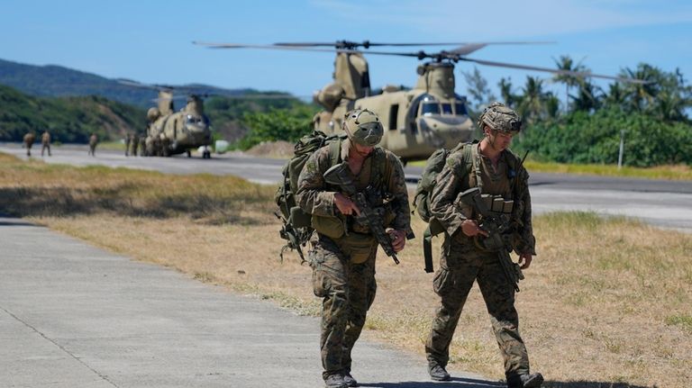 U.S. soldiers disembark inside the Naval Base Camilo Osias in...