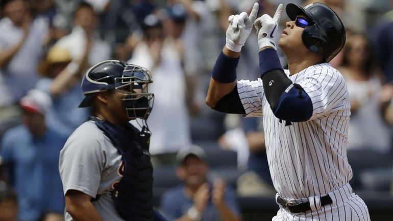 Alex Rodriguez gestures after hitting a solo home run in...