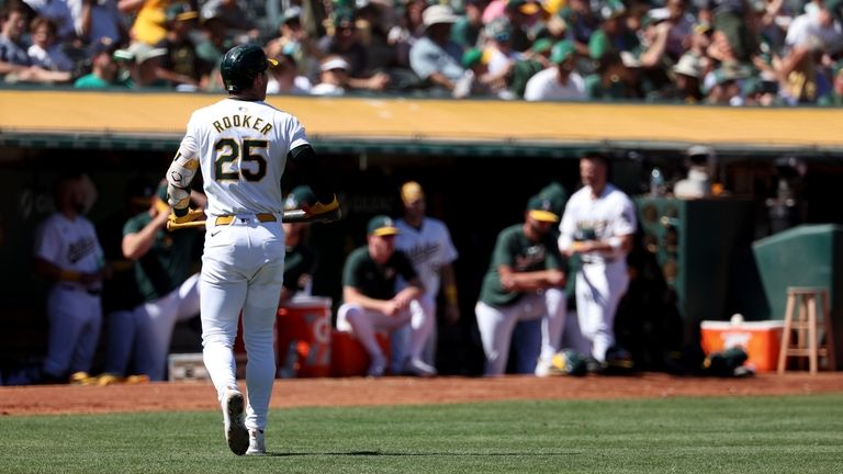 Oakland Athletics' Brent Rooker (25) walks back to the dugout...