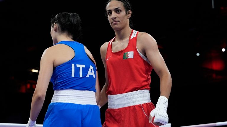 Algeria's Imane Khelif, right, after defeating Italy's Angela Carini, left,...