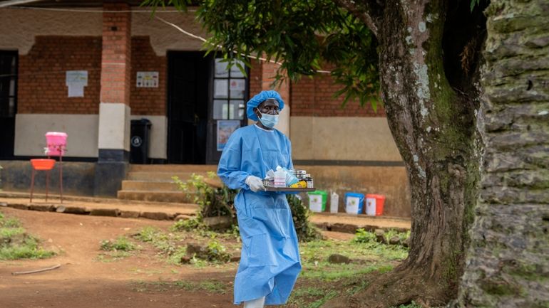 A health worker carries medication to be giving to a...