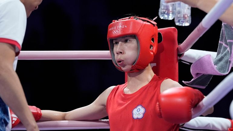 Taiwan's Lin Yu-ting rests between rounds against Uzbekistan's Sitora Turdibekova...