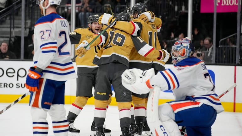Vegas Golden Knights players celebrate after right wing Reilly Smith...
