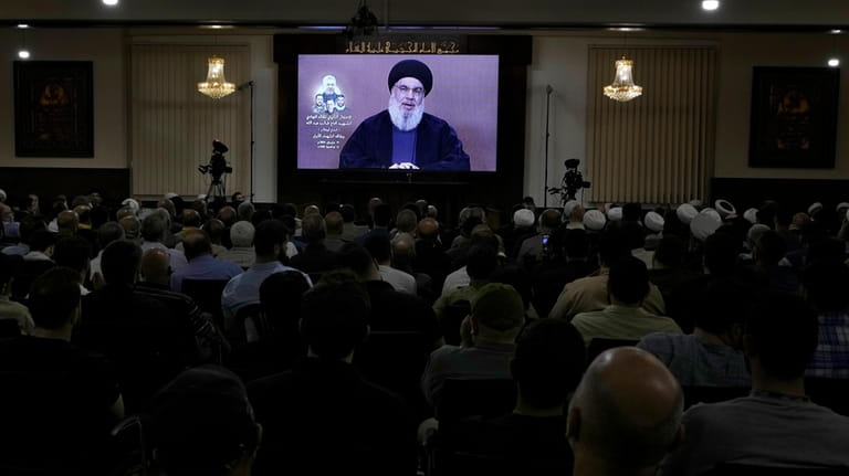 Hezbollah supporters watch a speech given by Hezbollah leader Sayyed...