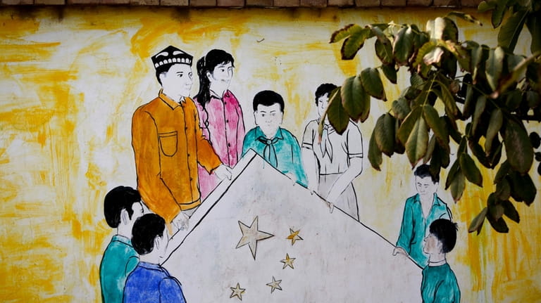 A mural showing Uighur and Han Chinese men and women...
