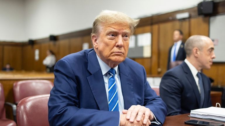 Former President Donald Trump awaits the start of proceedings on...