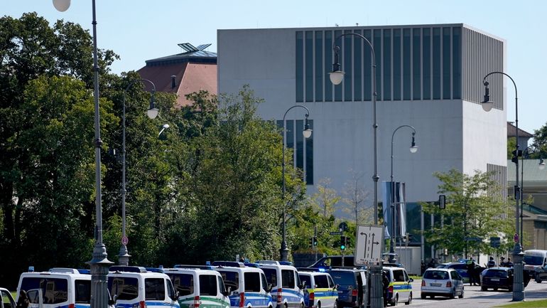 Police cars parked on a street next to the museum...