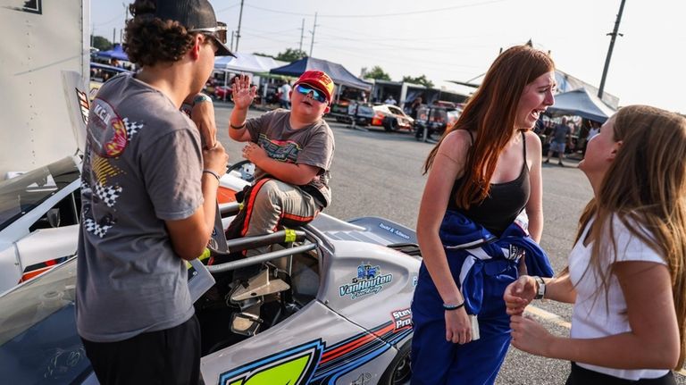 From left, crew member Cillian Tennant, race driver Daxx Halpin,...