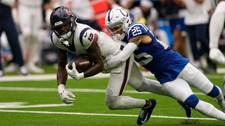 Houston Texans wide receiver Nico Collins (12) is tackled by...