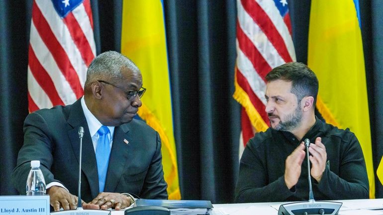 Defense Secretary Lloyd Austin, left and Ukrainian President Volodymyr Zelenskyy...