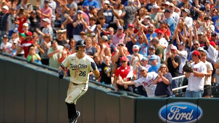 Minnesota Twins' Max Kepler runs past first base and celebrates...