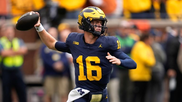 Michigan quarterback Davis Warren throws against the Texas in the...