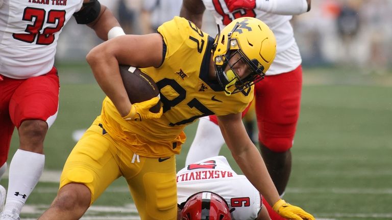 West Virginia's Kole Taylor (87) is tackled near the end...