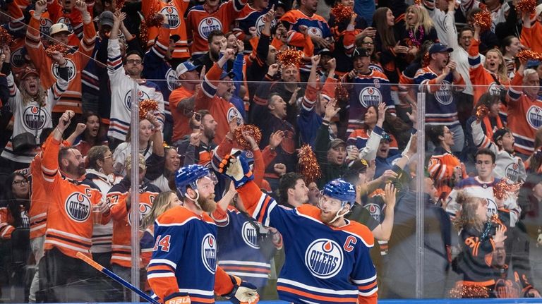 Edmonton Oilers' Mattias Ekholm (14) and Connor McDavid (97) celebrate...