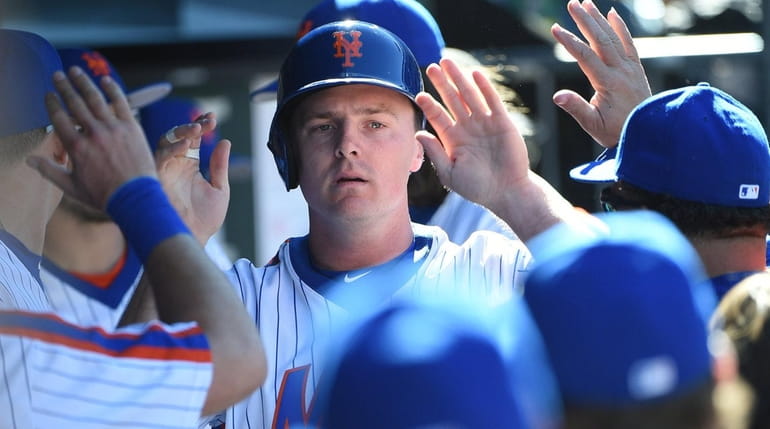 New York Mets rightfielder Jay Bruce is greeted in the...