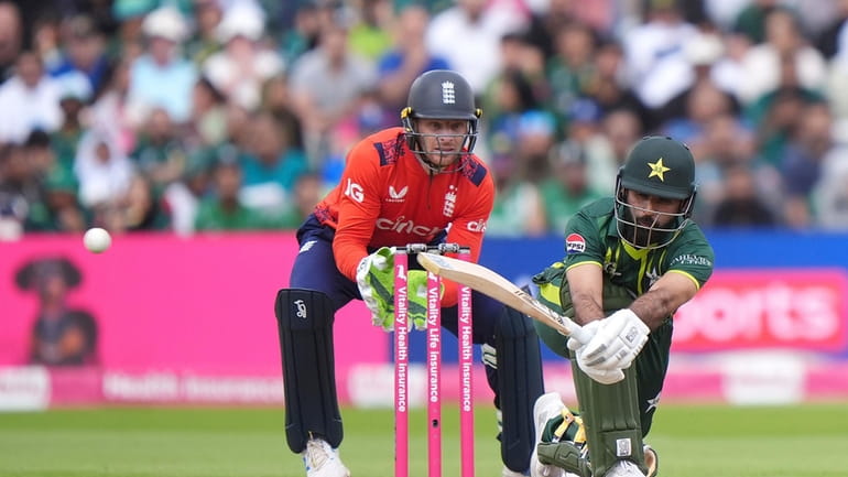 Pakistan's Fakhar Zaman hits out past England wicket keeper Jos...
