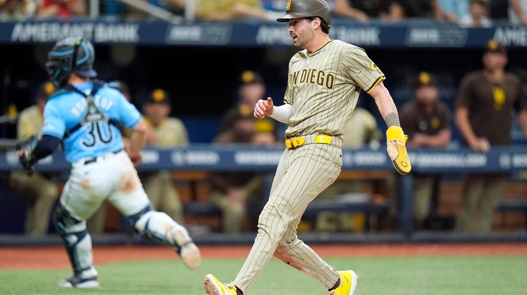 San Diego Padres' Tyler Wade scores on a sacrifice fly...