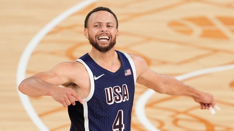 United States' Stephen Curry (4) reacts after winning a men's...