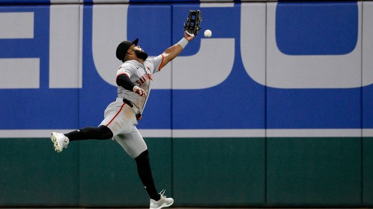 San Francisco Giants center fielder Heliot Ramos misses a ball...