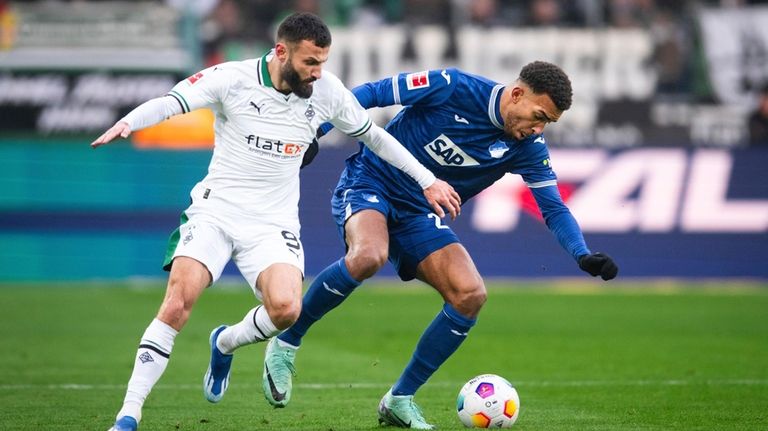 Gladbach's Franck Honorat, left, and Hoffenheim's Kevin Akpoguma fight for...