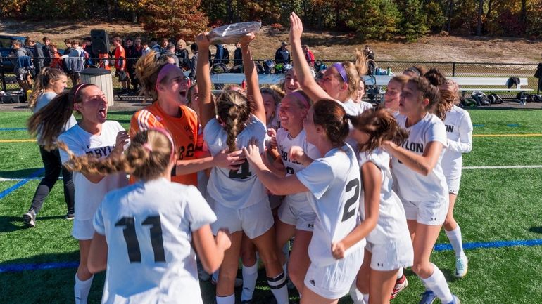 Babylon celebrates its 2-1 victory over Center Moriches in the...