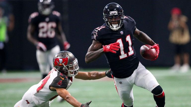 Falcons wide receiver Julio Jones runs against Buccaneers cornerback Brent...