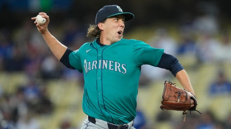 Seattle Mariners starting pitcher Logan Gilbert throws during the first...