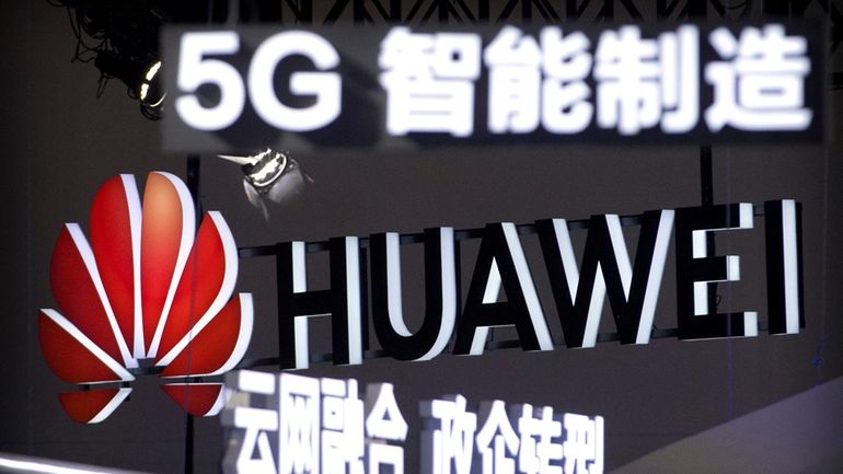 In this Sept. 26, 2018, file photo, signs promoting 5G...