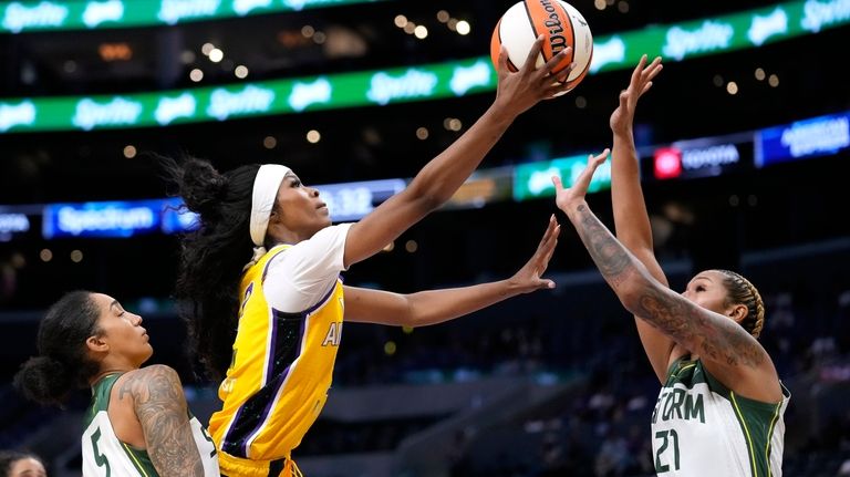 Los Angeles Sparks' Rickea Jackson, center, shoots as Seattle Storm...