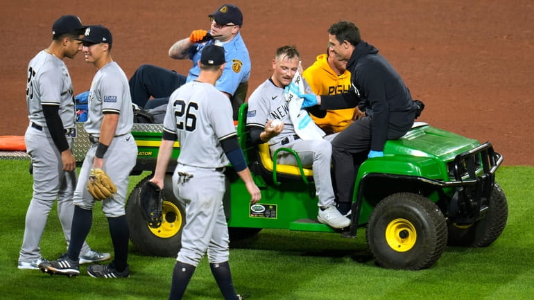 Yankees relief pitcher Anthony Misiewicz is taken off the field...