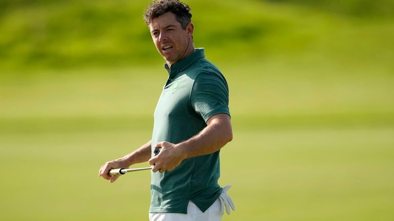 Rory McIlroy, of Ireland, watches his shot on the fifth...