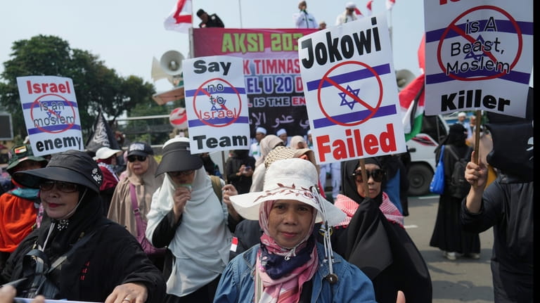 Protesters march during a protest in Jakarta, Indonesia, Monday, March...