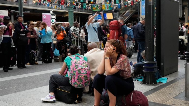 A traveler waits inside the Gare du Nord train station...